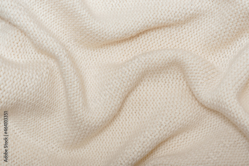 Beige knitted background with folds texture