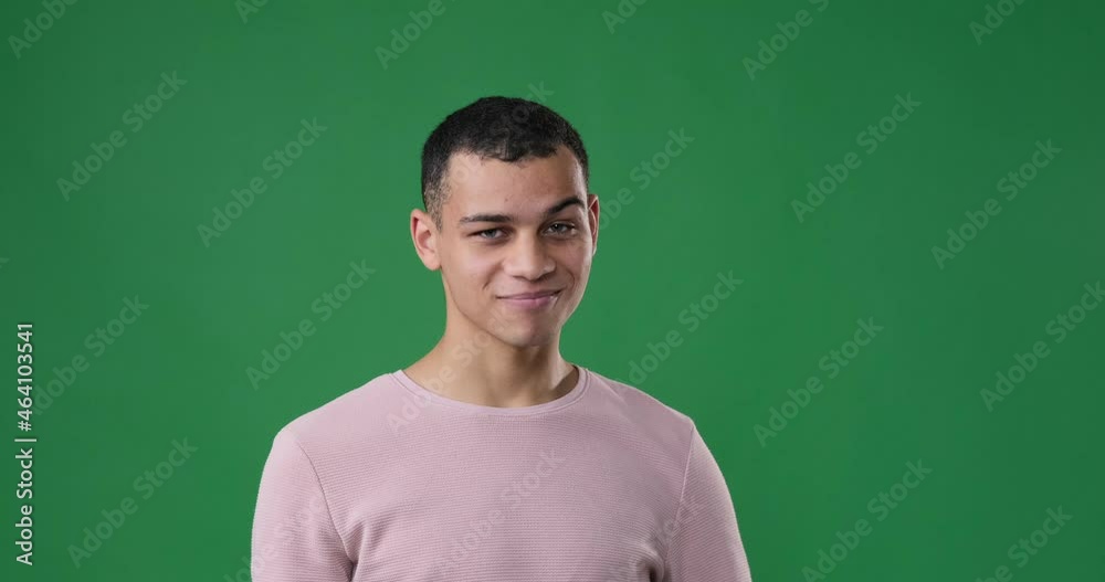 Man pointing finger and giving call me gesture over green background