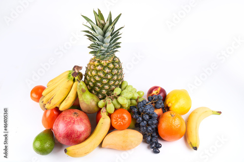Mix of fresh juicy colorful exotic tropical fruits on white background