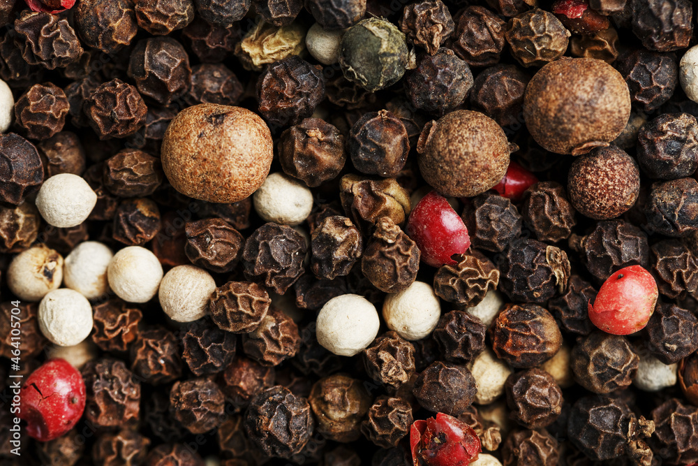 A mixture of peppercorns as a textural background in full screen. A mixture of peppercorns as a textural background in full screen.