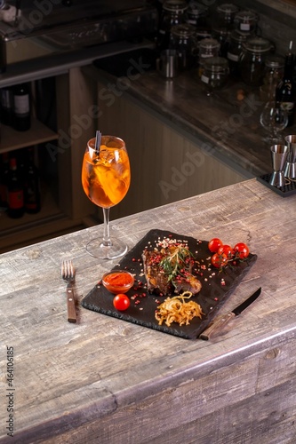Wineglass and steak with vegetables in restaurant