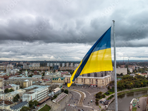 Flag of Ukraine, autumn city aerial view on central streets near river Lopan embankment, Skver Strilka, Pavlivska Square in Kharkiv, Ukraine photo
