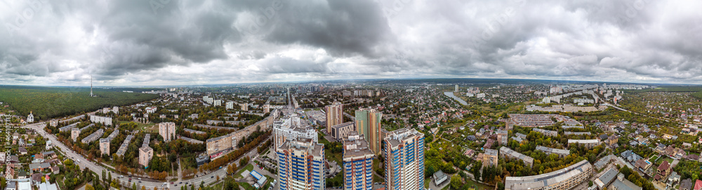 Fototapeta premium Multistory modern high buildings cityscape aerial view. Kharkiv city Pavlovo Pole district drone big wide panorama on Nauky ave with epic dark clouds
