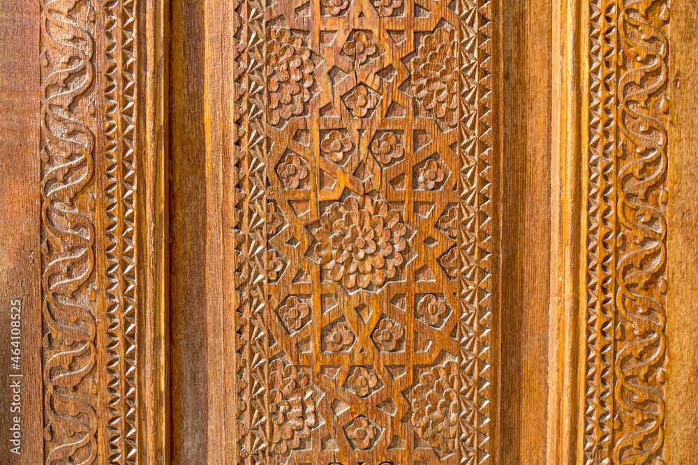 Wooden carved antique door as background ancient vintage pattern of Asian peoples, ancient east Kazakhstan Uzbekistan
