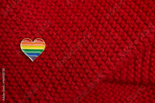 Lgbt symbol rainbow heart icon. Same sex love. Warm knitted red background.