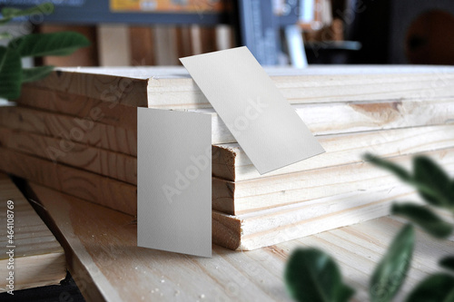 Clean minimal business card mockup on plank with leaves
