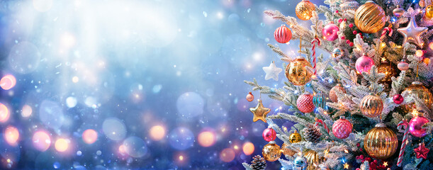 Christmas Tree - Ornaments And Snow In Blue Background With Shiny Lights