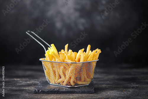 Принти на полотні French fries in fryer basket on dark background