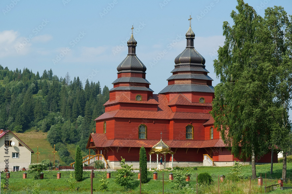 Red church in The Volosianka village in Carpathian Mountains, Ukraine