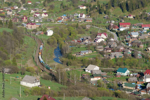 Train in village in Carpathian Mountains, Ukraine photo