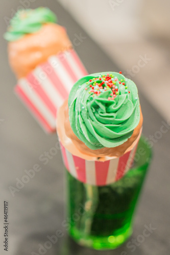 Giant Sweet Cupcake Cake Pop with Green Frosting and pink chocolate and multi colored Sprinkles