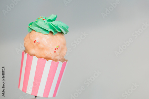Giant Sweet Cupcake Cake Pop with Green Frosting and pink chocolate and multi colored Sprinkles