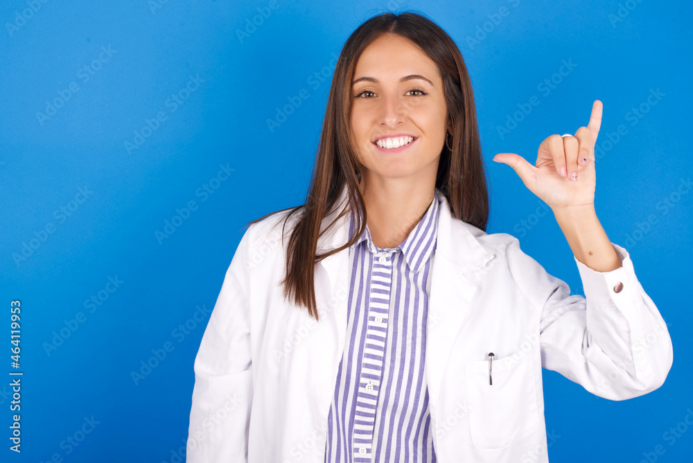 young european doctor girl wearing white medical gown on white background showing up number six Liu with fingers gesture in sign Chinese language young european doctor girl wearing white medical gown on white background showing up number six Liu with fingers gesture in sign Chinese language