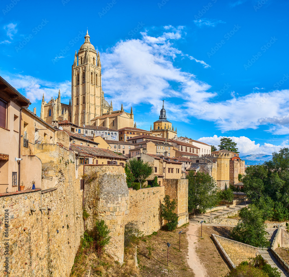 The wall of the old town of Segovia, with the Bell tower of the Cathedral in the background. View from Segovia Museum viewpoint, Calle del Socorro street. Segovia, Spain.