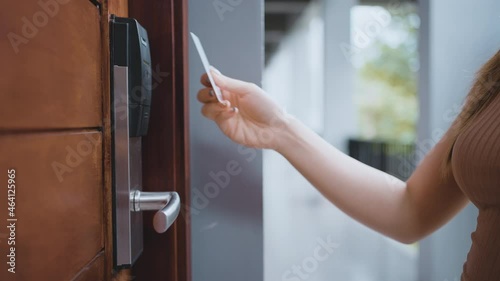 Closeup female's hand opening the room by key card access the hotel room. 4K slow-motion footage