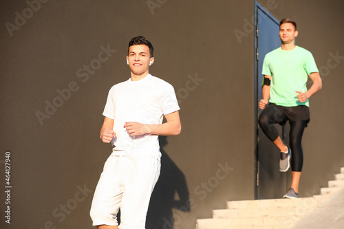 Sporty young man running do...