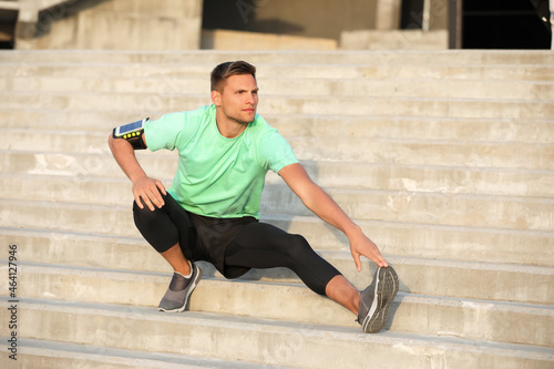 Sporty young man stretching...