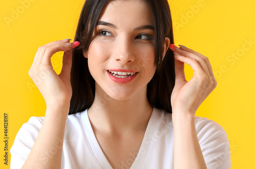 Pretty young woman putting ...