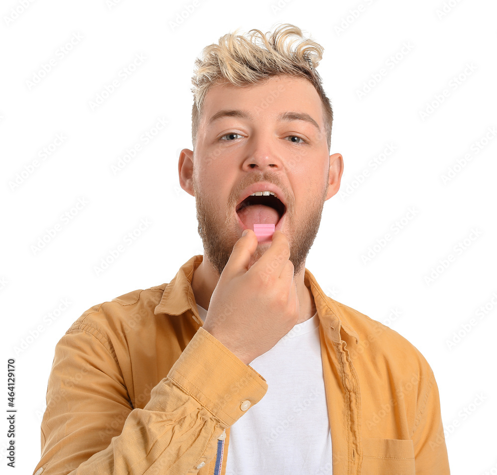 Young man with chewing gum on white background Young man with chewing gum on white background