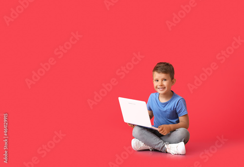 Cute little boy using lapto...