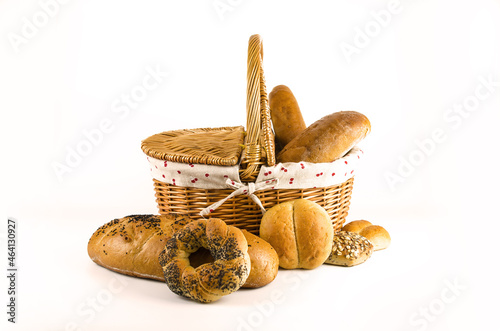 Basket with bread and whole wheat bread on white background (ID: 464130927)