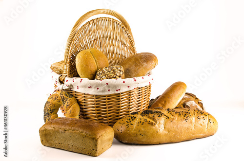 Basket with bread and whole wheat bread on white background (ID: 464130928)
