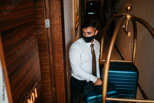 Photography Bellboy with luggage cart in hotel hallway