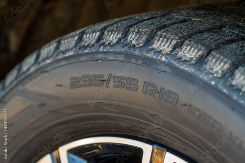 Close up view of tire with tire width, height and wheel diameter designation. Tire size types labels. photo