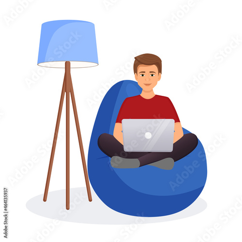 Man sits on a bean bag chair and works at a computer. Remote work, office at home, programming, freelance. Study at home in quarantine. Vector illustration.
