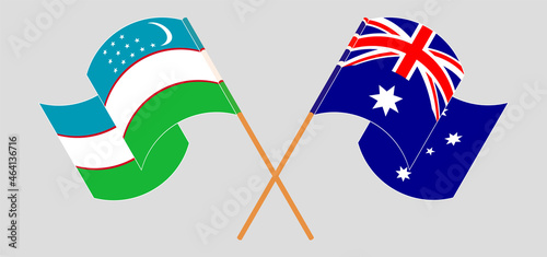 Crossed and waving flags of Australia and Uzbekistan