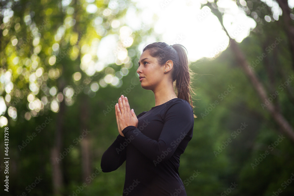 Adult woman practicing yoga at park