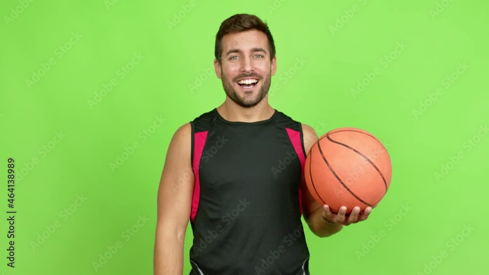 Handsome man playing basket and doing surprise gesture over isolated background Handsome man playing basket and doing surprise gesture over isolated background
