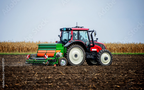 Sowing time. Farmer working in the field with a tractor. Agricultural concept