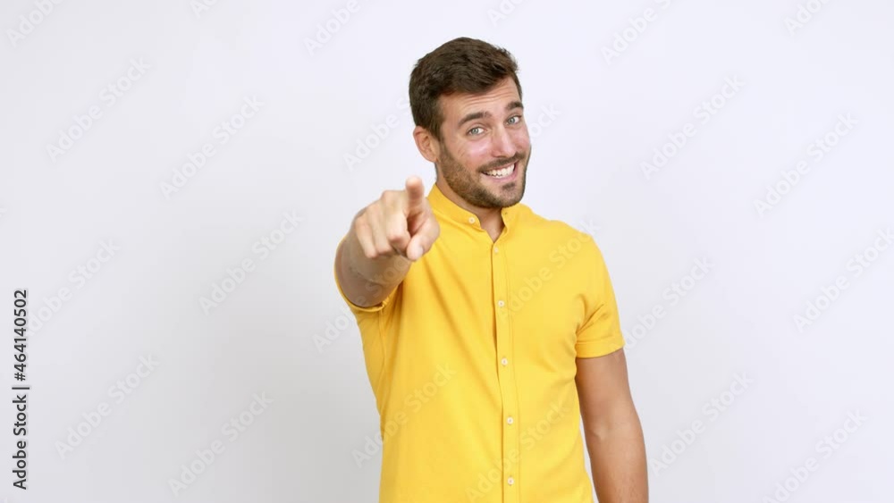 Handsome man points finger at you with a confident expression over isolated background Handsome man points finger at you with a confident expression over isolated background