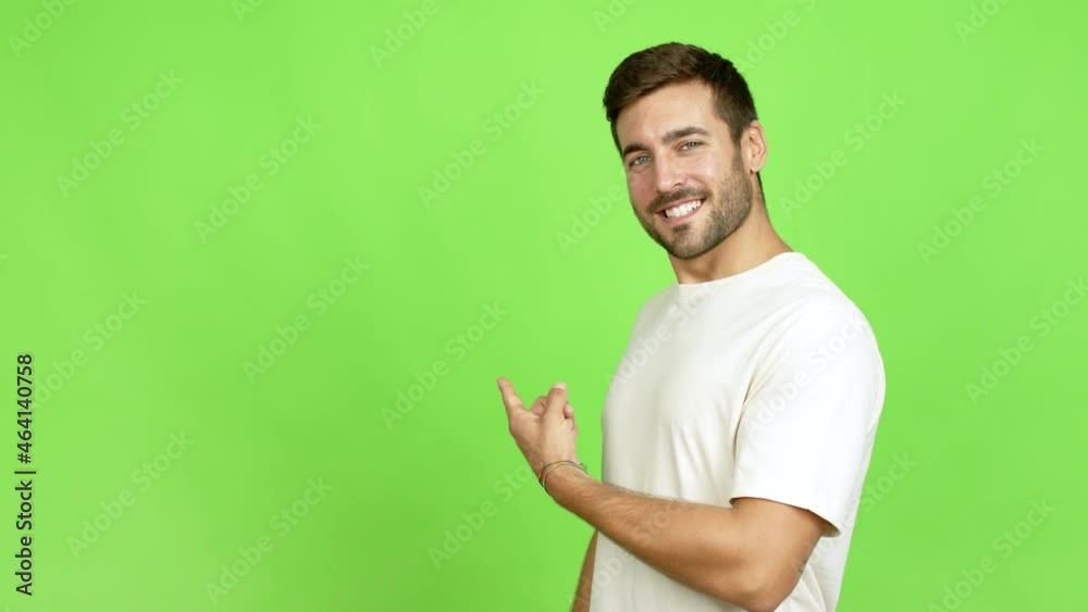 Handsome man pointing back and presenting a product over isolated background Handsome man pointing back and presenting a product over isolated background
