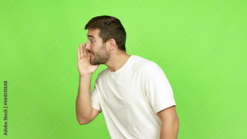 Handsome man shouting to the lateral and announcing something over isolated background Handsome man shouting to the lateral and announcing something over isolated background