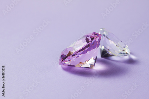 Purple precious gemstones for design gems jewellery. Big diamonds crystal on purple background.