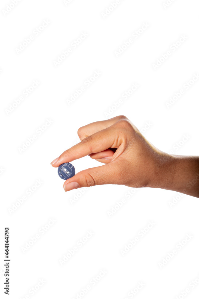 Hand holding blue clothes button. Isolated on white background. Hand holding blue clothes button. Isolated on white background.