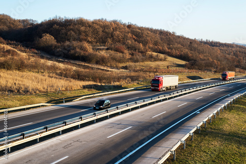 A large number of road vehicles. Cars and trucks in the highway.