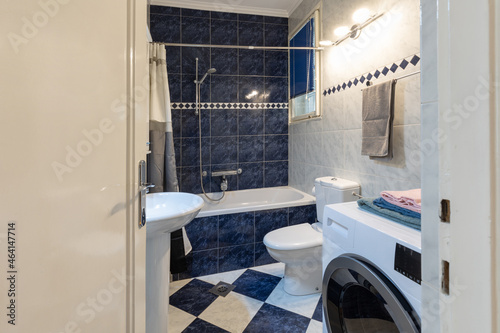 Tiled bathroom interior with bath tub