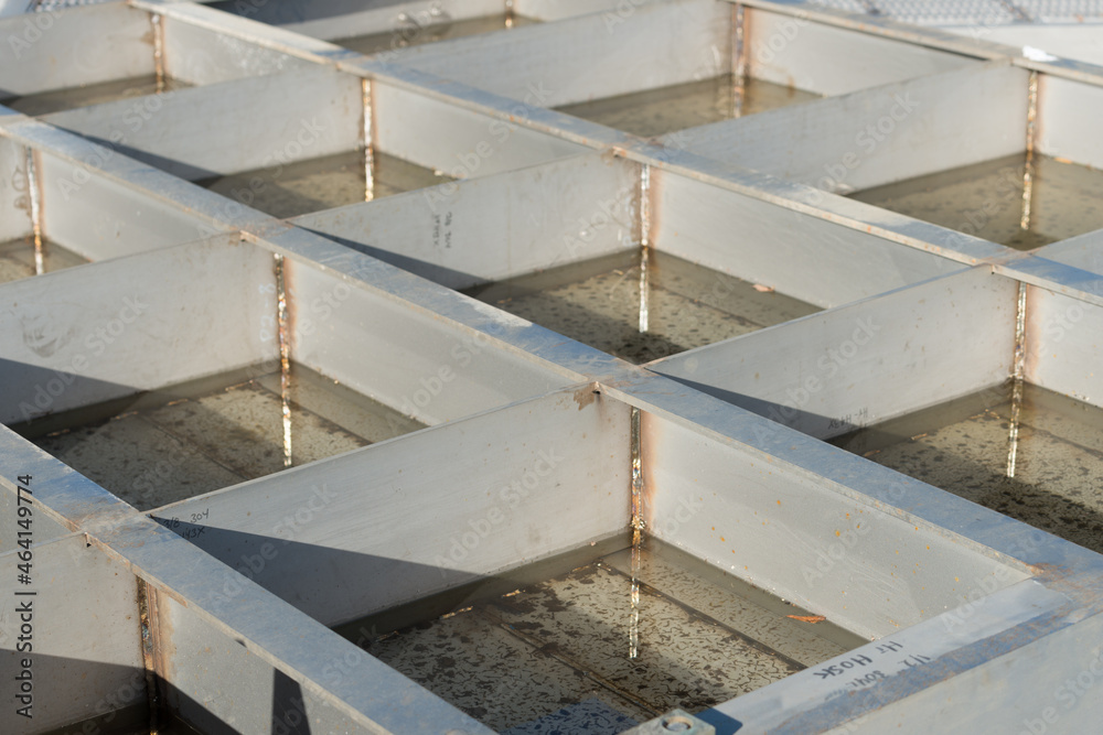 Fototapeta premium metal object with compartments filled with rain water