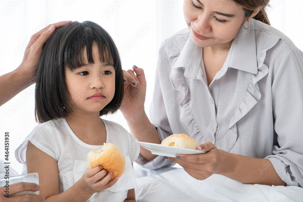 Unhappy Asian little girl feeling sick lethargic don't want to eat. Unhappy Asian little girl feeling sick lethargic don't want to eat.
