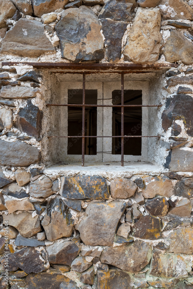 Square window on a brick wall protected with steel bars, concept of prision, captivity or protection from threft, lage copy-space Square window on a brick wall protected with steel bars, concept of prision, captivity or protection from threft, lage copy-space