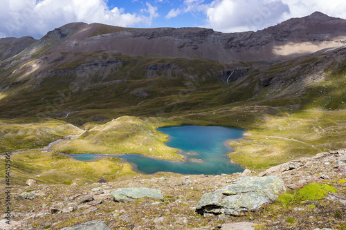 Hiking trail in Cogne valley, Aosta, Italy. Lake of Doreire in the high walloon of Grauson near the pass of Invergneux. Photo taken at 2800 meters of altitude.