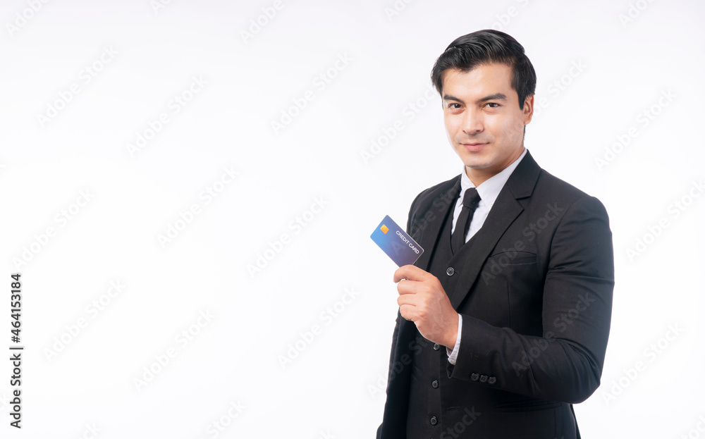 Payment transaction and financial concept. Success handsome businessman wear suit with tie holding credit card mockup in own hand while standing with copy space over isolated white background. Payment transaction and financial concept. Success handsome businessman wear suit with tie holding credit card mockup in own hand while standing with copy space over isolated white background.