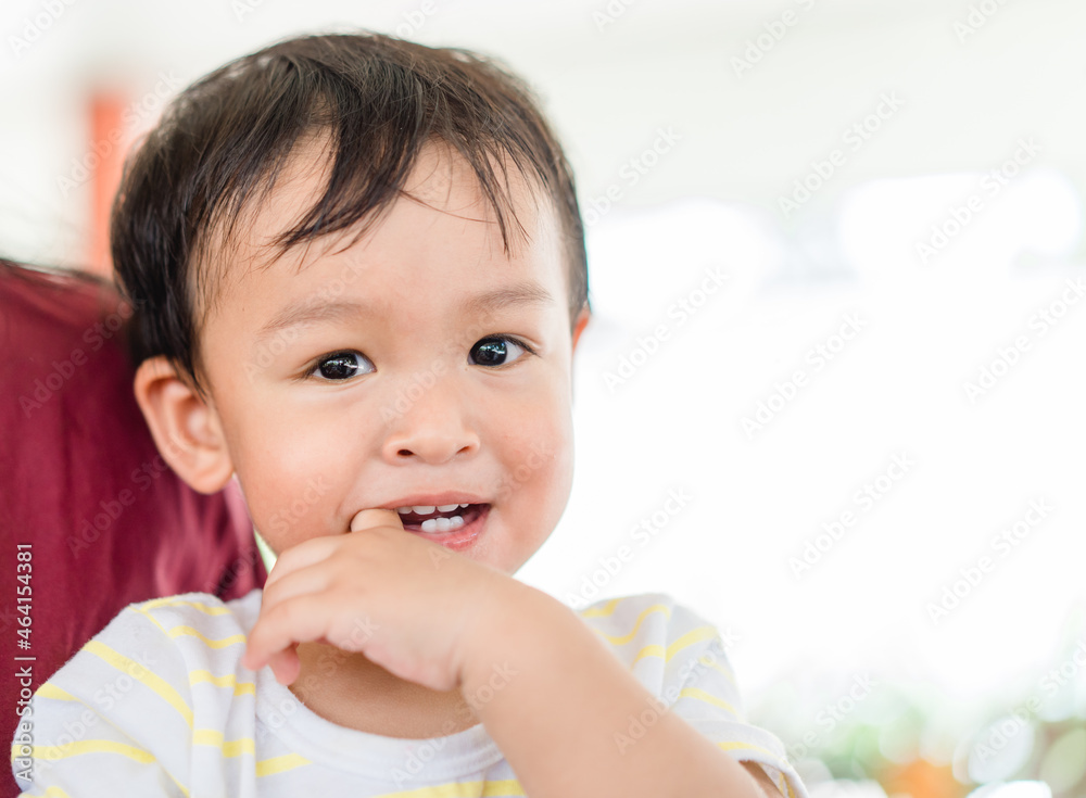 baby infant kid boy putting fingers on mouth touching first milk teeth gums pain toothache.Bad breath in baby kid.Adorable mix race baby male toddler in pain for new baby teeth.shy kid boy.dental. baby infant kid boy putting fingers on mouth touching first milk teeth gums pain toothache.Bad breath in baby kid.Adorable mix race baby male toddler in pain for new baby teeth.shy kid boy.dental.