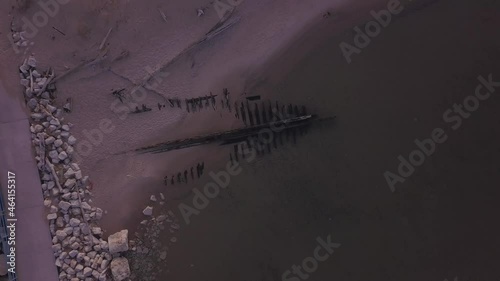 Rising rotating aerial of shipwreck The Contest on beach in Michigan photo