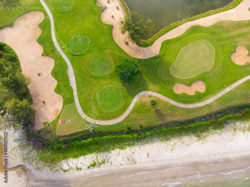 Golf course aerial view green grass near sea beach