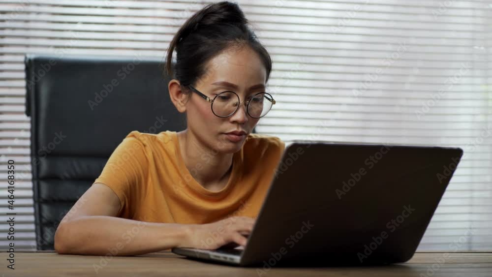 Asian woman working with laptop computer at home. Asian woman working with laptop computer at home.