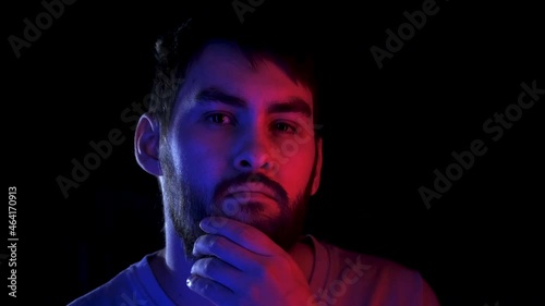 Portrait handsome man combing beard colorful neon led light. Fashion hipster prepare shave ultraviolet illuminance. Led lighting unshaven guy. Bearded people shaving neon illumination in ultra violet.